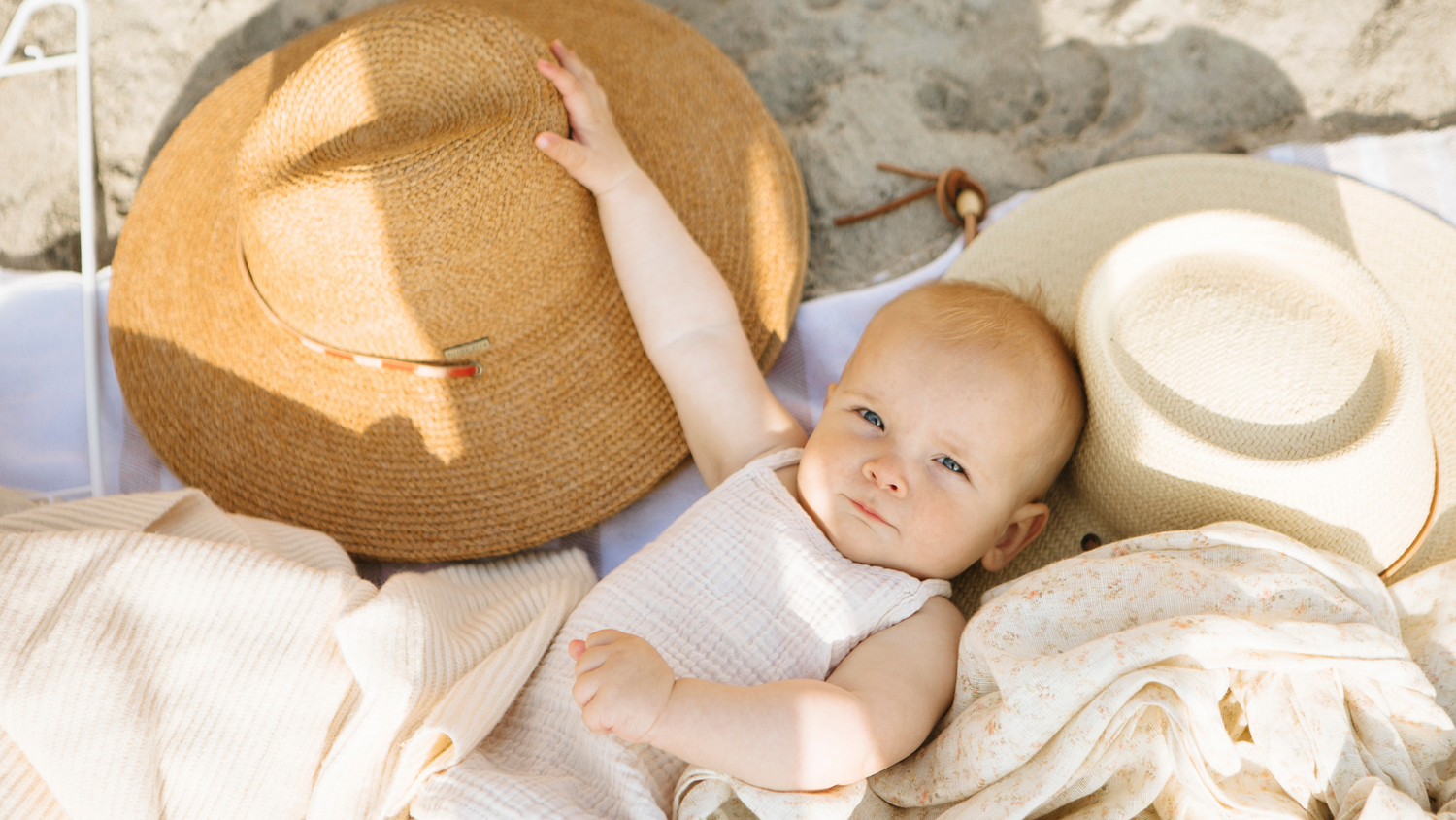 mothers day baby next to a hat