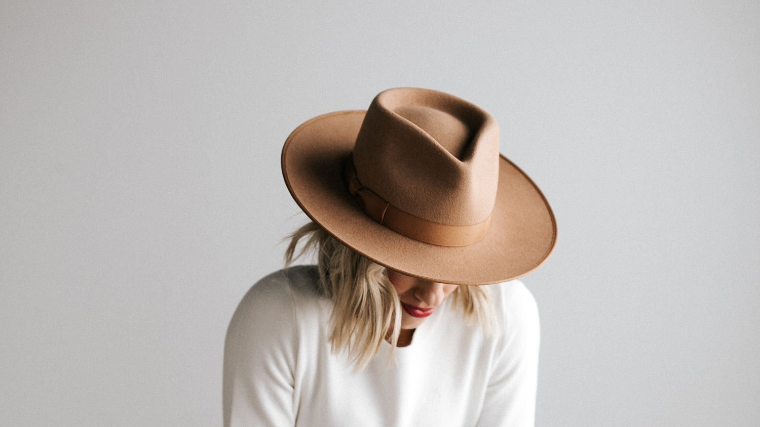 girl in hat looking down