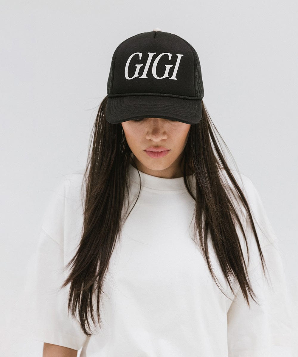 Gigi Pip trucker hats for women - Gigi Foam Trucker Hat - 100% polyester foam + mesh trucker hat with a curved brim featuring the word "Gigi" in a contrasting color as a design across the front panel [black]