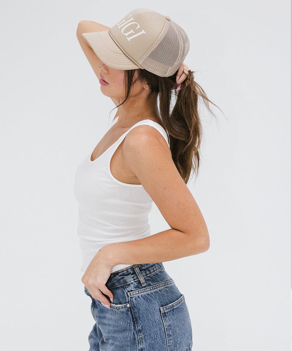 Gigi Pip trucker hats for women - Gigi Foam Trucker Hat - 100% polyester foam + mesh trucker hat with a curved brim featuring the word "Gigi" in a contrasting color as a design across the front panel [tan]