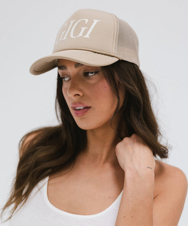 Gigi Pip trucker hats for women - Gigi Foam Trucker Hat - 100% polyester foam + mesh trucker hat with a curved brim featuring the word "Gigi" in a contrasting color as a design across the front panel [tan]