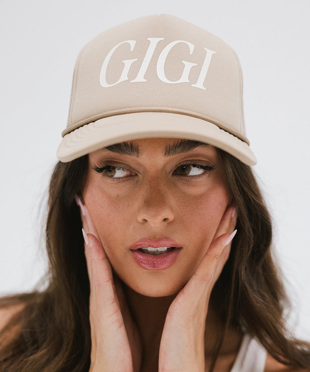 Gigi Pip trucker hats for women - Gigi Foam Trucker Hat - 100% polyester foam + mesh trucker hat with a curved brim featuring the word "Gigi" in a contrasting color as a design across the front panel [tan]