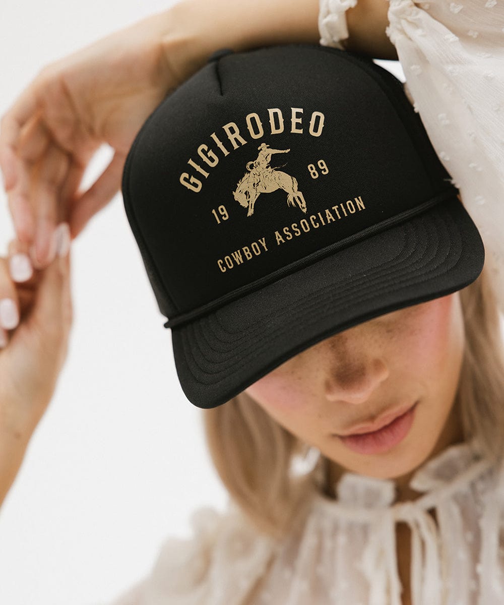 Gigi Pip trucker hats for women - Gigi Rodeo Foam Trucker Hat - 100% polyester foam + mesh trucker hat with a curved brim featuring the words "gigi rodeo" in a contrasting color as a design across the front panel [black]