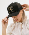 Gigi Pip trucker hats for women - Gigi Rodeo Foam Trucker Hat - 100% polyester foam + mesh trucker hat with a curved brim featuring the words "gigi rodeo" in a contrasting color as a design across the front panel [black]