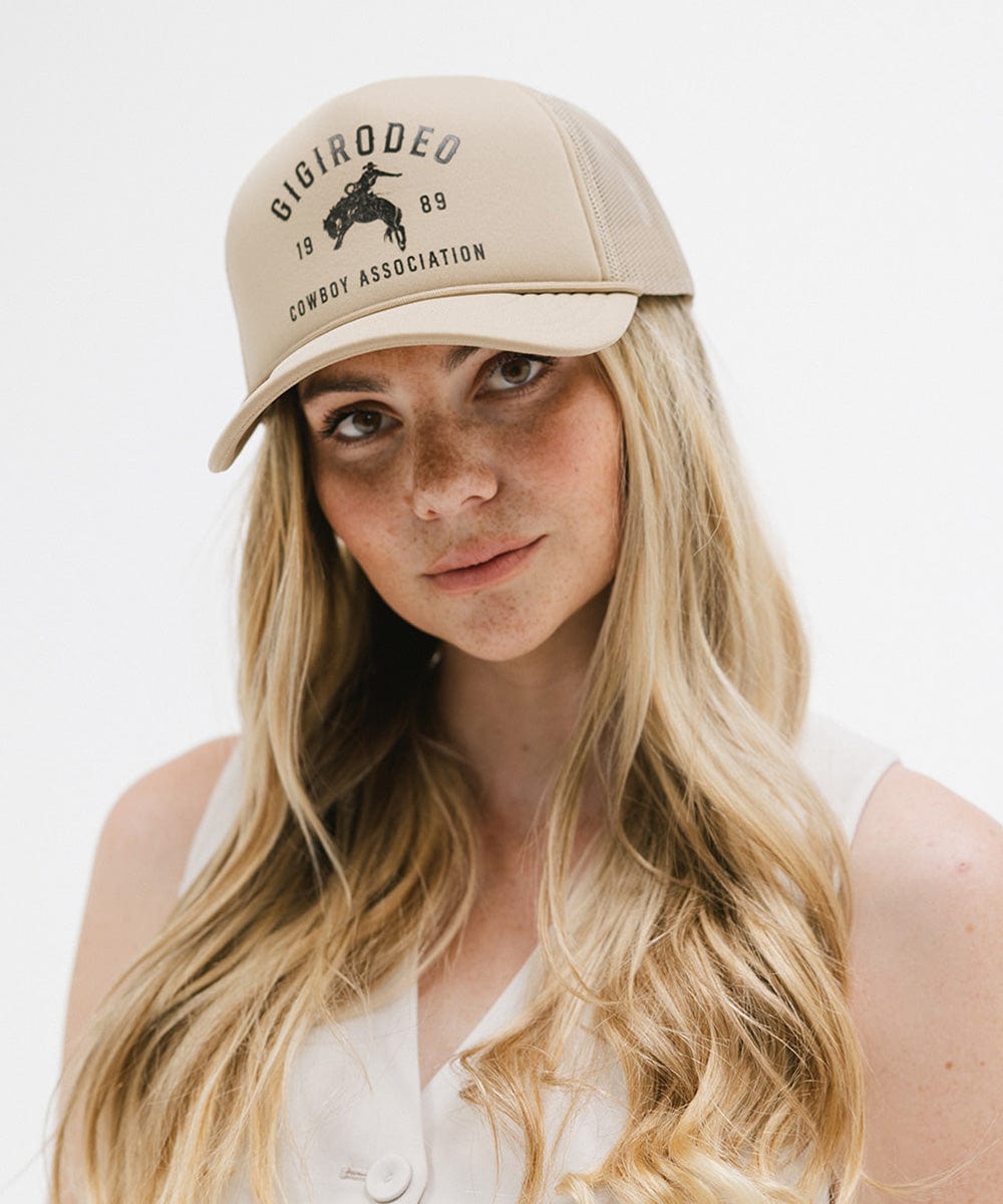 Gigi Pip trucker hats for women - Gigi Rodeo Foam Trucker Hat - 100% polyester foam + mesh trucker hat with a curved brim featuring the words "gigi rodeo" in a contrasting color as a design across the front panel [tan]