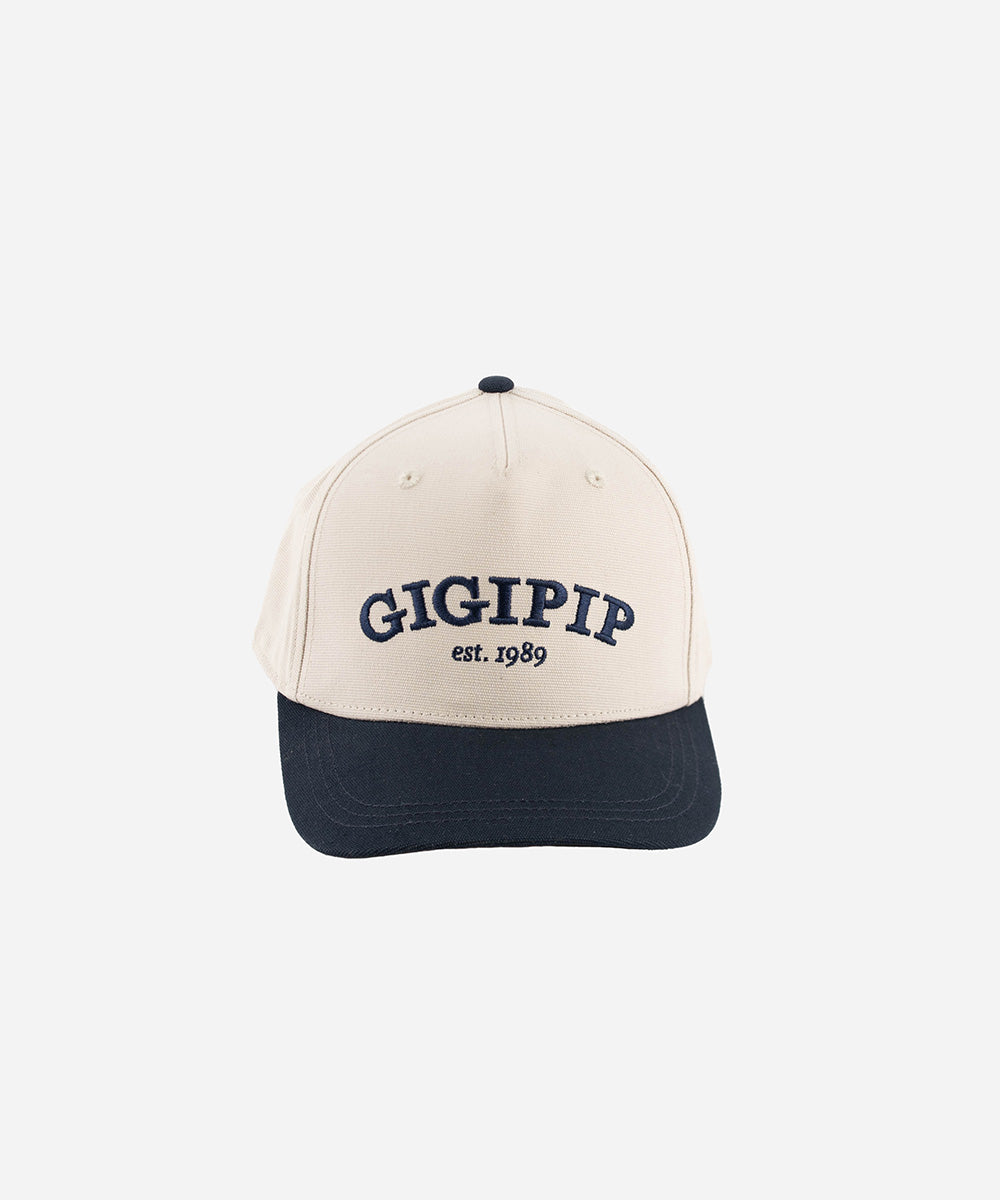 Gigi Pip trucker hats for women - Gigi Pip Canvas Trucker Hat - 100% Cotton Canvas w/ cotton sweatband + reinforced from panel with 100% polyester mesh trucker hats with gigi pip embroidered on the front panel with an adjustable velcro bag [cream-navy]