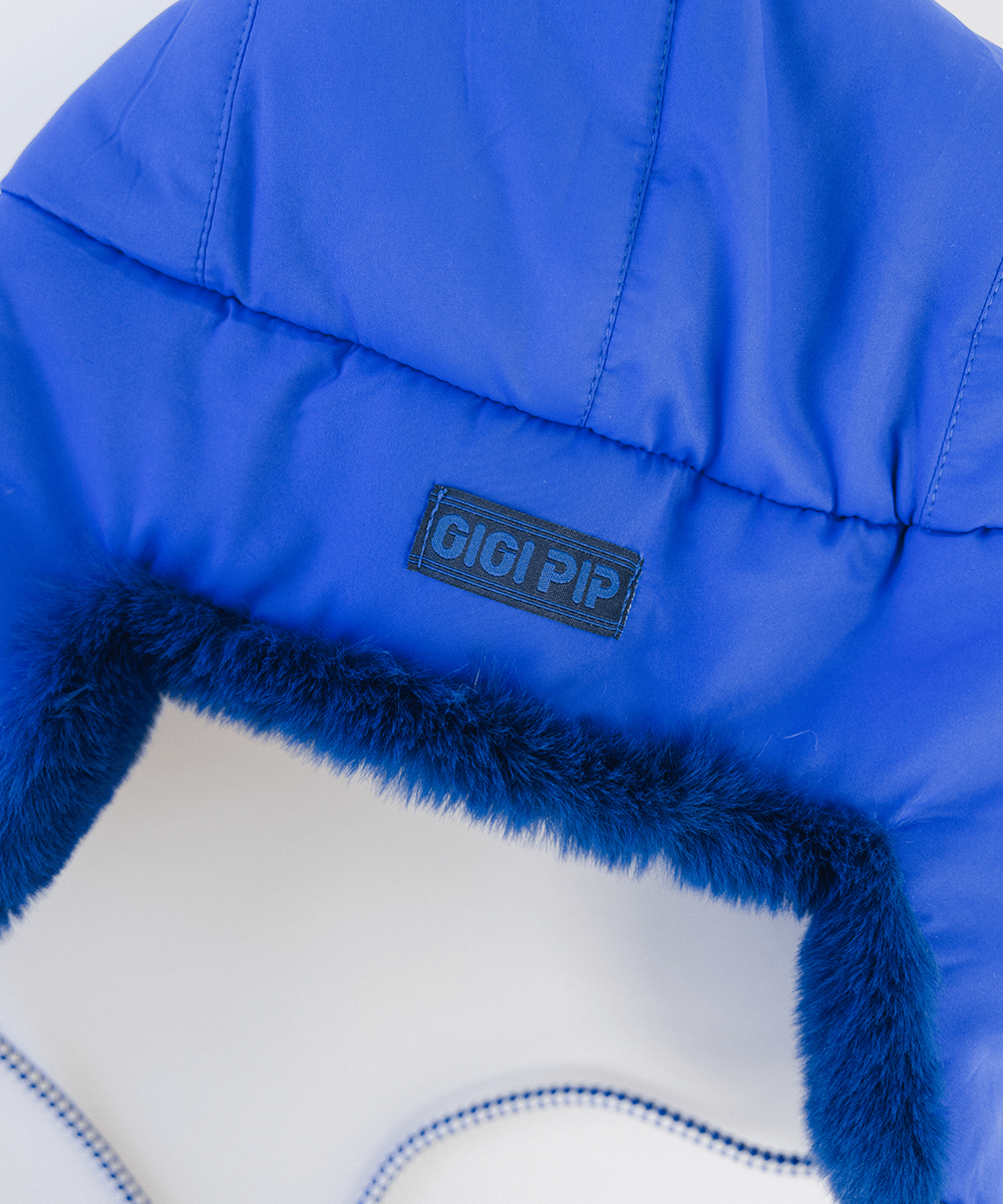 Gigi Pip winter hats for women - Leda Trapper Hat - 100% faux fur + polyester classic style inspired trapper hat featuring a retro limited edition holiday Gigi Pip logo [alpine blue]