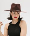 Gigi Pip felt hats for women - Raine Wide Brim Fedora - wide flat brim with a fedora crown, featuring a gold-plated removable paperclip brass chain with three faux pearls and a hand-sewn grosgrain band with the gold Gigi Pip bar around the crown, as well as a removable golden chain chinstrap [dark cherry]