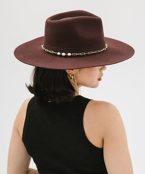 Gigi Pip felt hats for women - Raine Wide Brim Fedora - wide flat brim with a fedora crown, featuring a gold-plated removable paperclip brass chain with three faux pearls and a hand-sewn grosgrain band with the gold Gigi Pip bar around the crown, as well as a removable golden chain chinstrap [dark cherry]