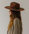 Gigi Pip felt hats for women - Raine Wide Brim Fedora - wide flat brim with a fedora crown, featuring a gold-plated removable paperclip brass chain with three faux pearls and a hand-sewn grosgrain band with the gold Gigi Pip bar around the crown, as well as a removable golden chain chinstrap [dark oak]