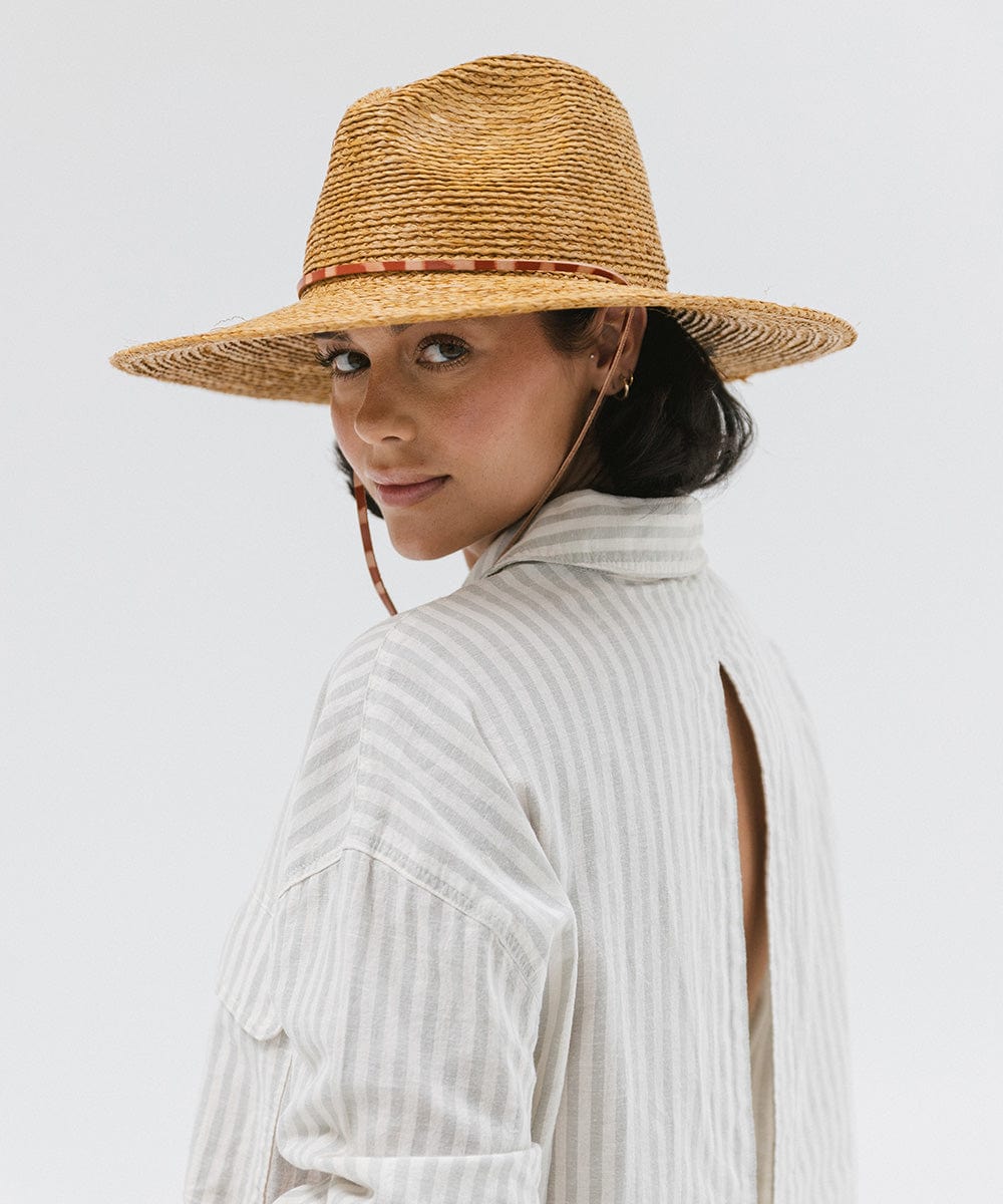 Gigi Pip straw hats for women - Ozzy Lifegaurd Hat - made of a tight weave raffia straw with a relaxed a-line brim, hand-painted leather chinstrap [honey]