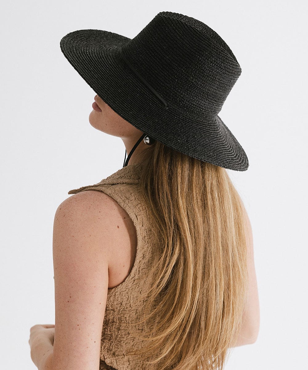 Gigi Pip straw hats for women - Ozzy Lifegaurd Hat - made of a tight weave raffia straw with a relaxed a-line brim, hand-painted leather chinstrap [black]