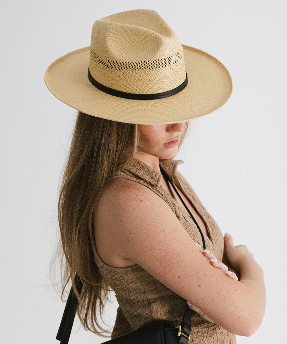 Gigi Pip panama straw for women - Saguaro Wide Brim Natural - a pinched fedora crown with a wide and slightly upturned brim, featuring a matte black leather band that is Gigi Pip embossed around the crown [natural]