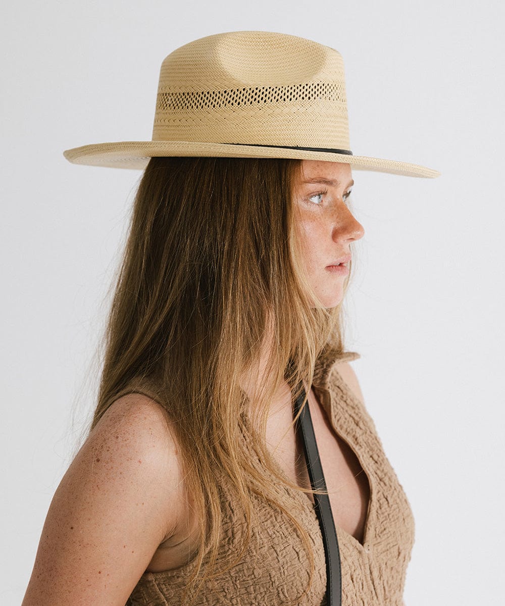 Gigi Pip panama straw for women - Saguaro Wide Brim Natural - a pinched fedora crown with a wide and slightly upturned brim, featuring a matte black leather band that is Gigi Pip embossed around the crown [natural]